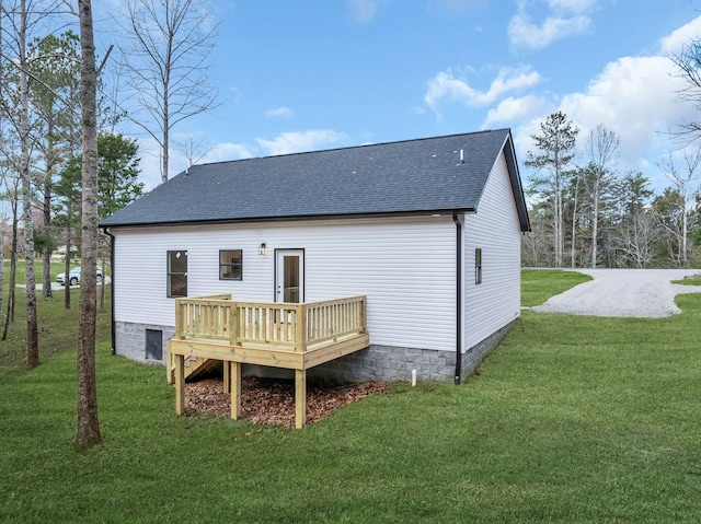 back of property with a lawn and a deck