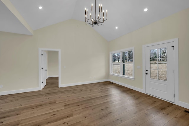 interior space with a chandelier, high vaulted ceiling, and wood-type flooring