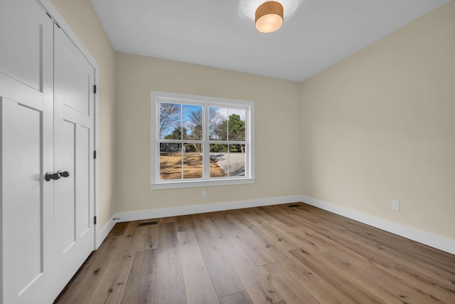 spare room featuring light wood-type flooring