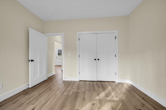 unfurnished bedroom with light hardwood / wood-style floors and a closet