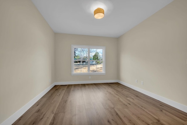 empty room with light hardwood / wood-style flooring