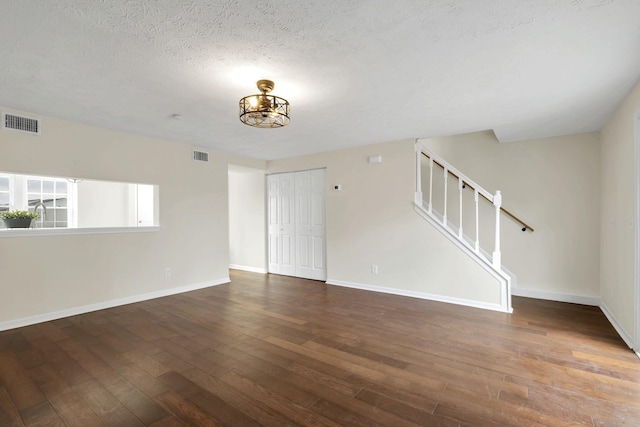 empty room featuring hardwood / wood-style flooring and a textured ceiling