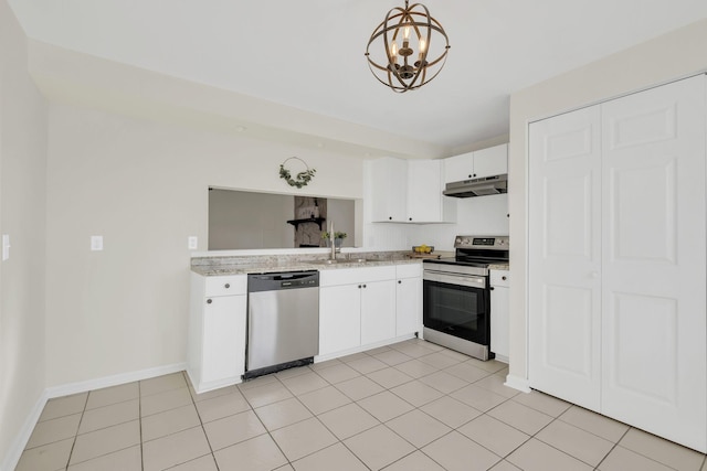 kitchen with decorative light fixtures, white cabinets, light tile patterned floors, and appliances with stainless steel finishes