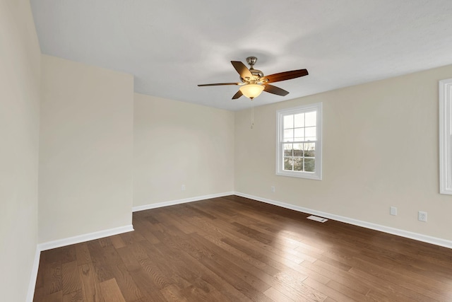 spare room featuring ceiling fan and dark hardwood / wood-style floors