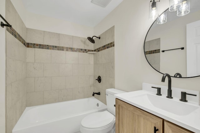 full bathroom featuring toilet, vanity, and tiled shower / bath combo