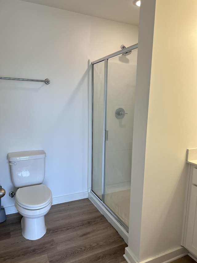 302 Williams Ave Unit 110, Madison, TN 37115 - bathroom featuring toilet, a shower stall, wood finished floors, and vanity