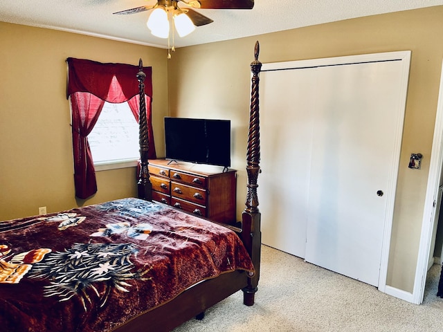 bedroom featuring a closet, ceiling fan, and light carpet