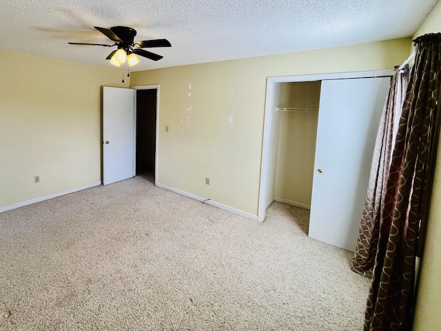 unfurnished bedroom with a textured ceiling, a closet, and ceiling fan