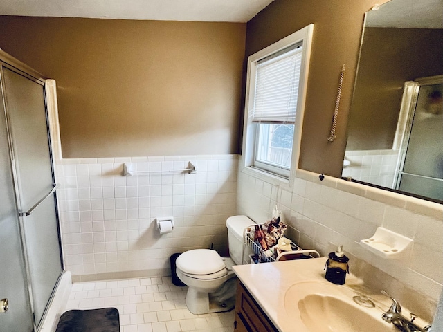 bathroom with an enclosed shower, tile patterned floors, tile walls, toilet, and vanity