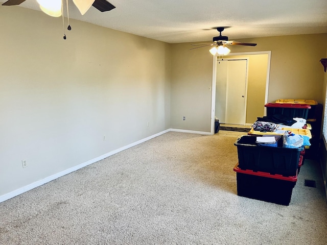 unfurnished room with ceiling fan and a textured ceiling