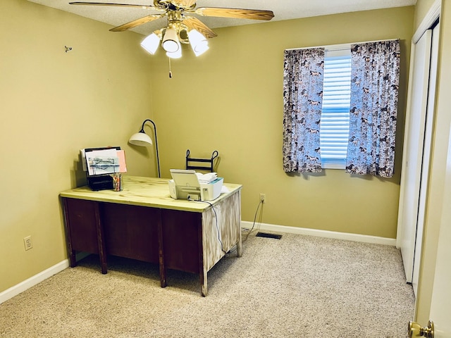 carpeted office with ceiling fan