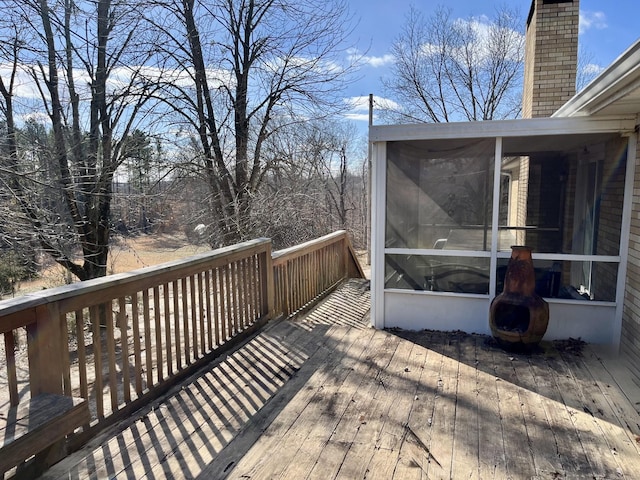 wooden deck featuring a sunroom