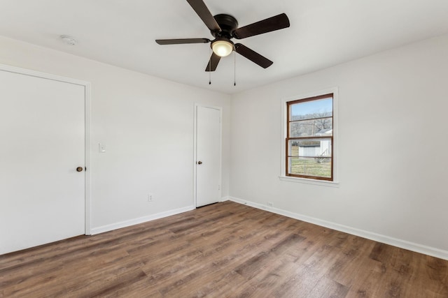 empty room with ceiling fan and wood-type flooring