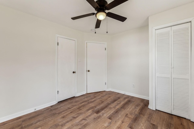 unfurnished bedroom featuring hardwood / wood-style flooring and ceiling fan