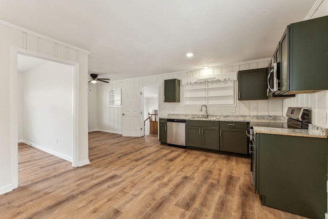 kitchen featuring crown molding, stainless steel appliances, sink, and light hardwood / wood-style flooring