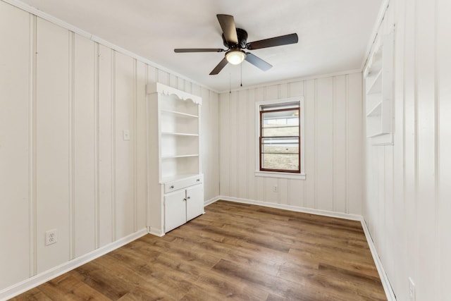 unfurnished room featuring ornamental molding, hardwood / wood-style floors, and ceiling fan