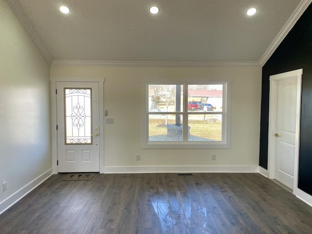 foyer featuring a healthy amount of sunlight, dark hardwood / wood-style floors, lofted ceiling, and ornamental molding