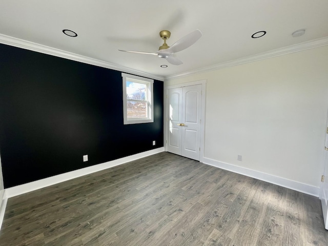 spare room featuring ceiling fan, dark hardwood / wood-style flooring, and ornamental molding