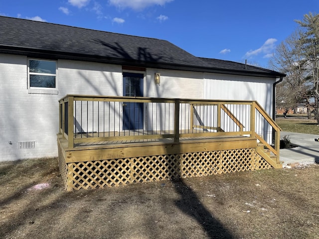 rear view of property featuring a deck