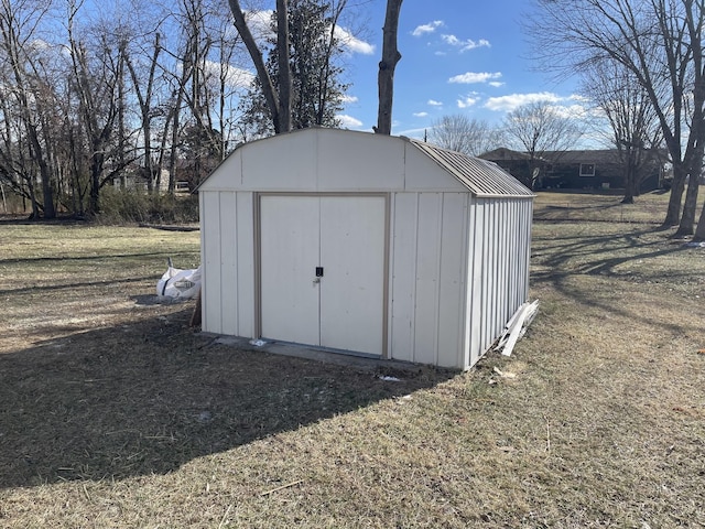 view of outbuilding featuring a lawn