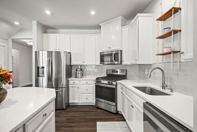 kitchen featuring sink, white cabinetry, decorative backsplash, and stainless steel appliances