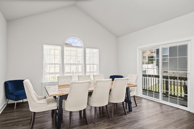 dining area featuring high vaulted ceiling, dark wood-type flooring, and a wealth of natural light