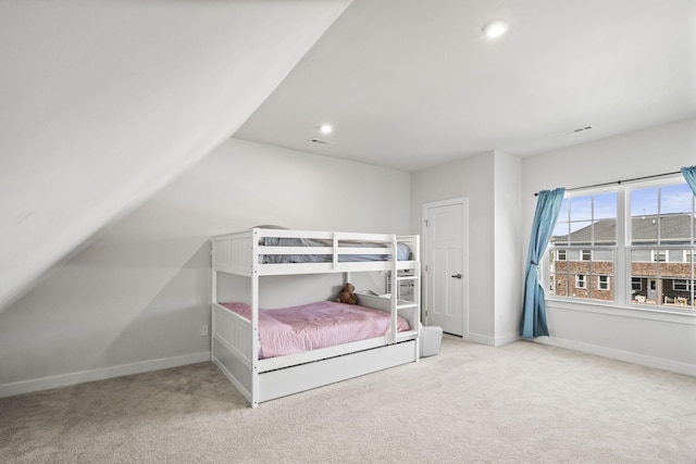 bedroom with light carpet and lofted ceiling