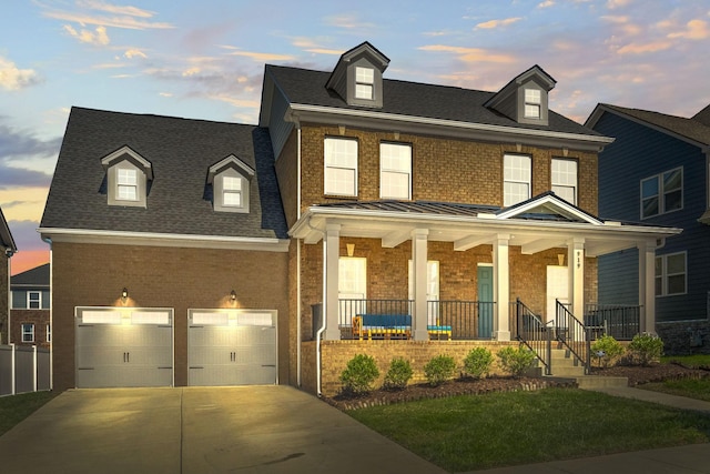 view of front of property featuring a porch and a garage