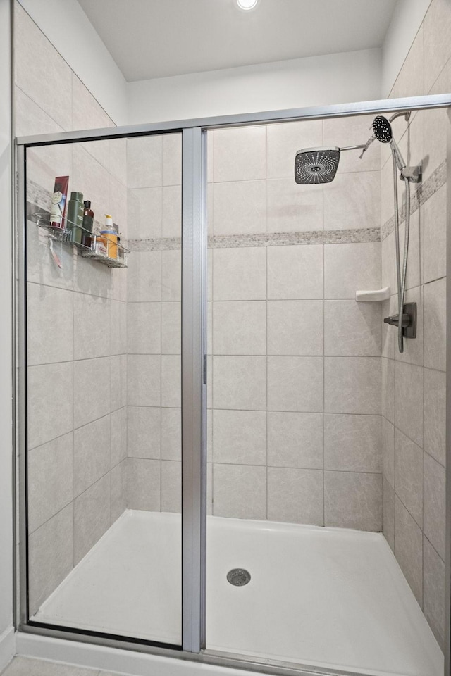 bathroom with a shower with shower door