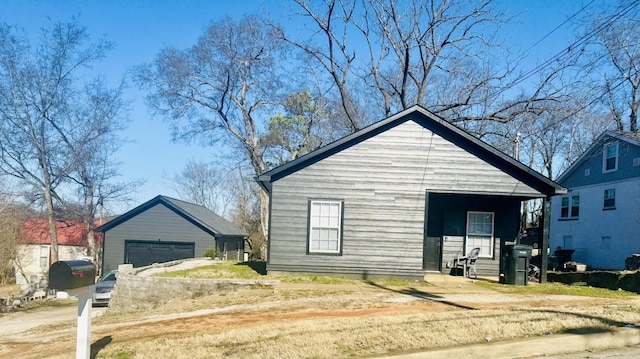 bungalow-style home featuring an outbuilding and a garage