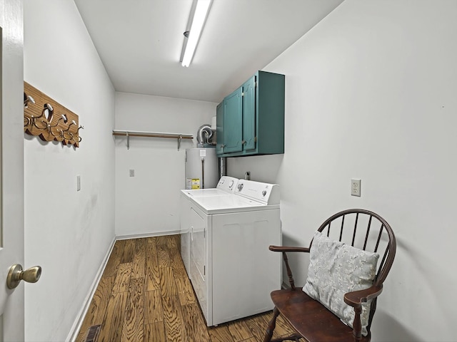 laundry room with gas water heater, cabinets, washer and dryer, and dark hardwood / wood-style flooring