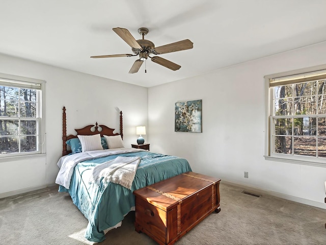 bedroom with ceiling fan and light carpet