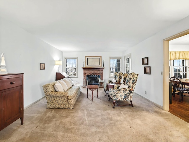 living room with a brick fireplace and light carpet