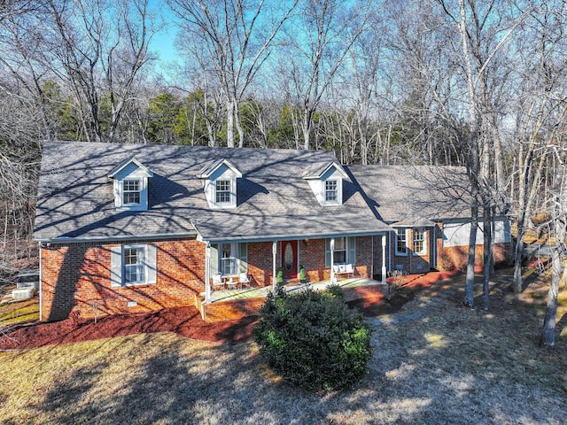 new england style home featuring covered porch