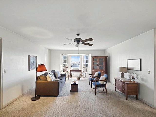 living room featuring ceiling fan and light colored carpet