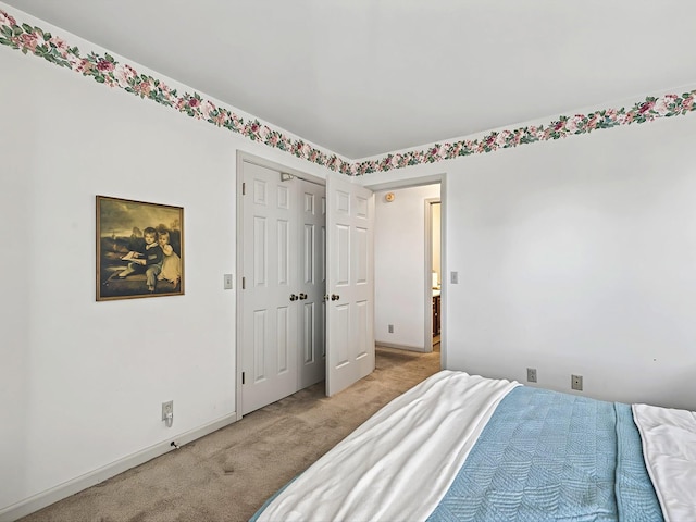 carpeted bedroom featuring a closet