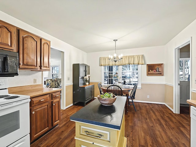 kitchen with pendant lighting, a center island, dark hardwood / wood-style floors, a notable chandelier, and electric range