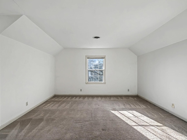 bonus room with carpet floors and vaulted ceiling