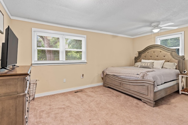 bedroom featuring ornamental molding, ceiling fan, light colored carpet, and a textured ceiling