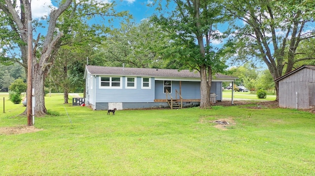 rear view of property with a lawn