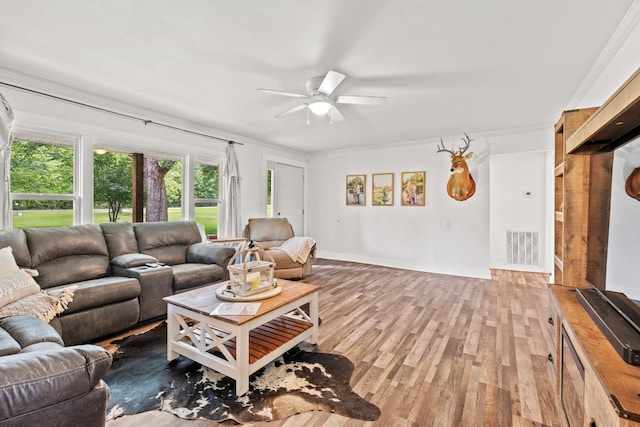 living room with ceiling fan, hardwood / wood-style floors, and crown molding