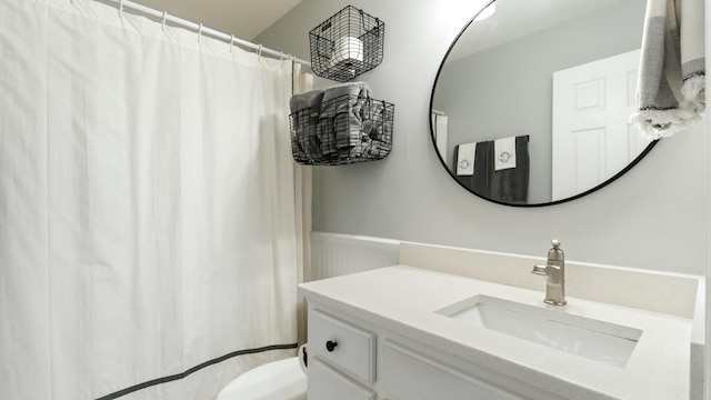 bathroom with toilet and vanity