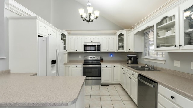 kitchen featuring sink, white cabinets, appliances with stainless steel finishes, and pendant lighting