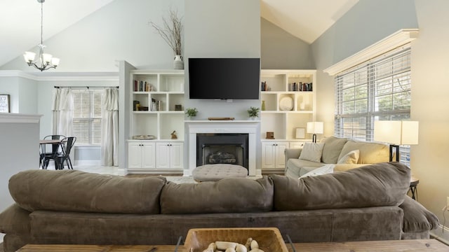 living room with a healthy amount of sunlight, an inviting chandelier, and lofted ceiling