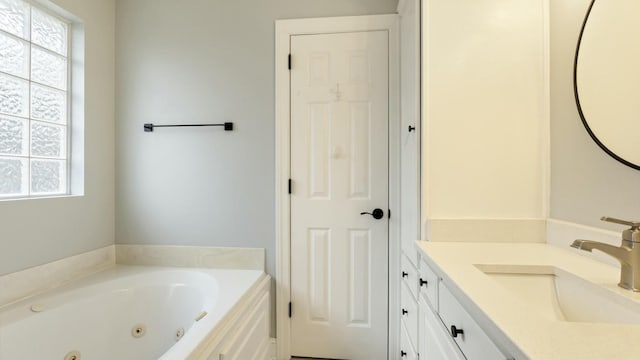 bathroom featuring vanity, a bath, and a healthy amount of sunlight