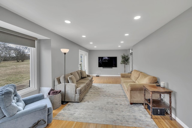 living room with a wealth of natural light and hardwood / wood-style floors