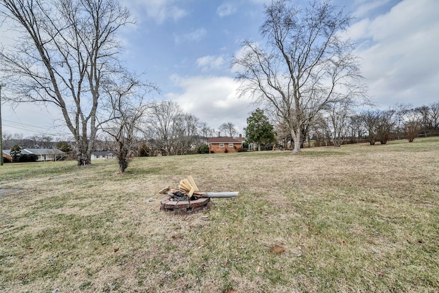 view of yard with an outdoor fire pit