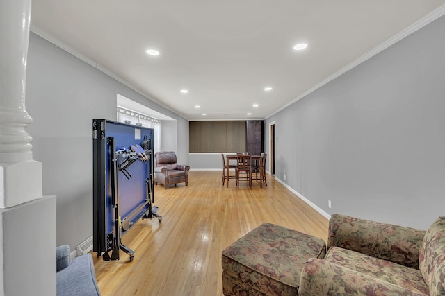 interior space featuring light hardwood / wood-style floors and crown molding