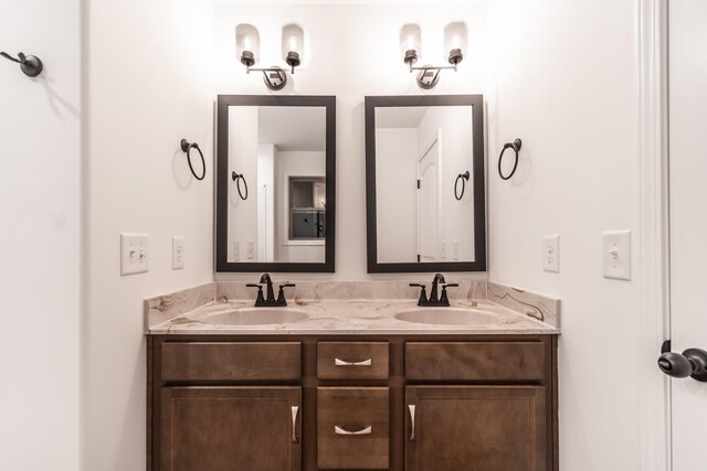 bathroom with double vanity and a sink