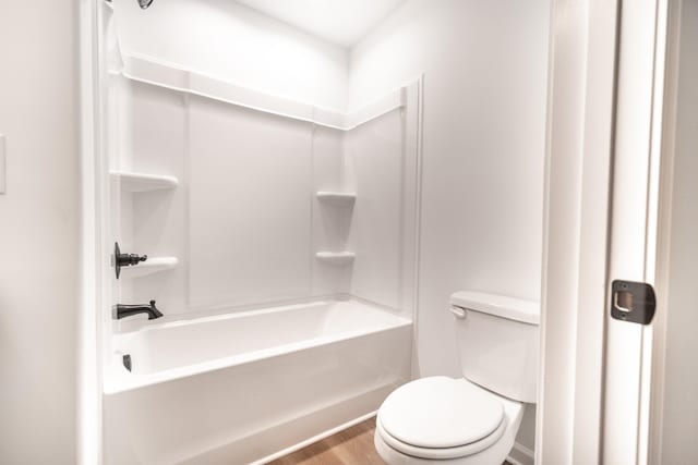 full bath with toilet,  shower combination, and wood finished floors